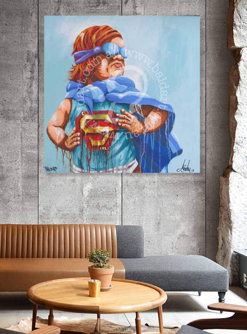 Painting of a superhero character holding a Superman logo on a wall in a living room.