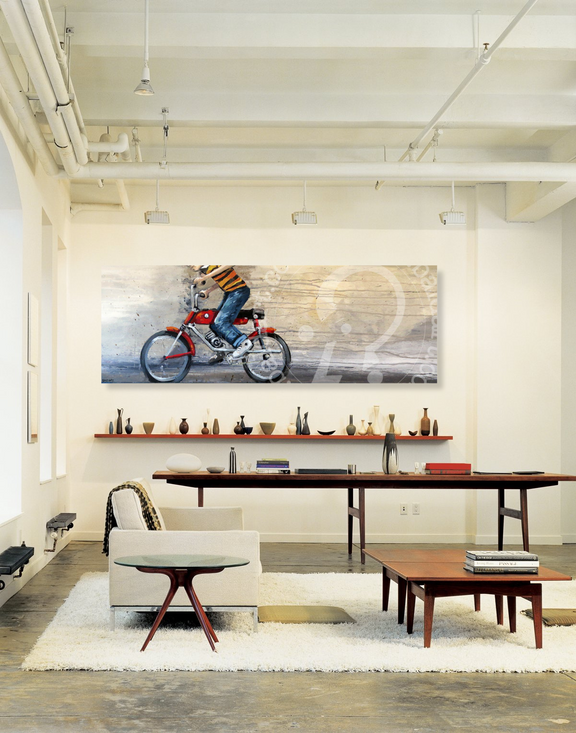 Modern interior with a painting of a person on a bicycle, a table, and chairs.