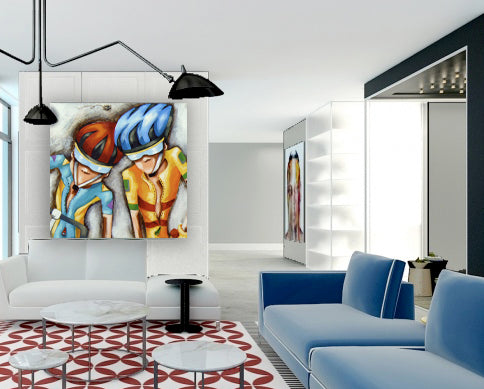 Modern living room featuring contemporary cycling wall art by Bald Art, showing two cyclists in colorful blue and yellow jerseys from The Cycle Series.