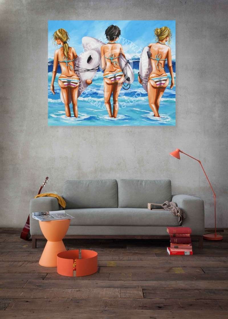 Painting of three women in swimsuits on a wall above a gray sofa.