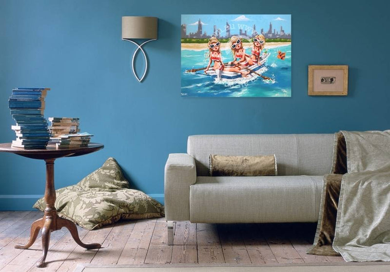 Living room with a gray sofa, wooden side table, and wall art of children on a beach.
