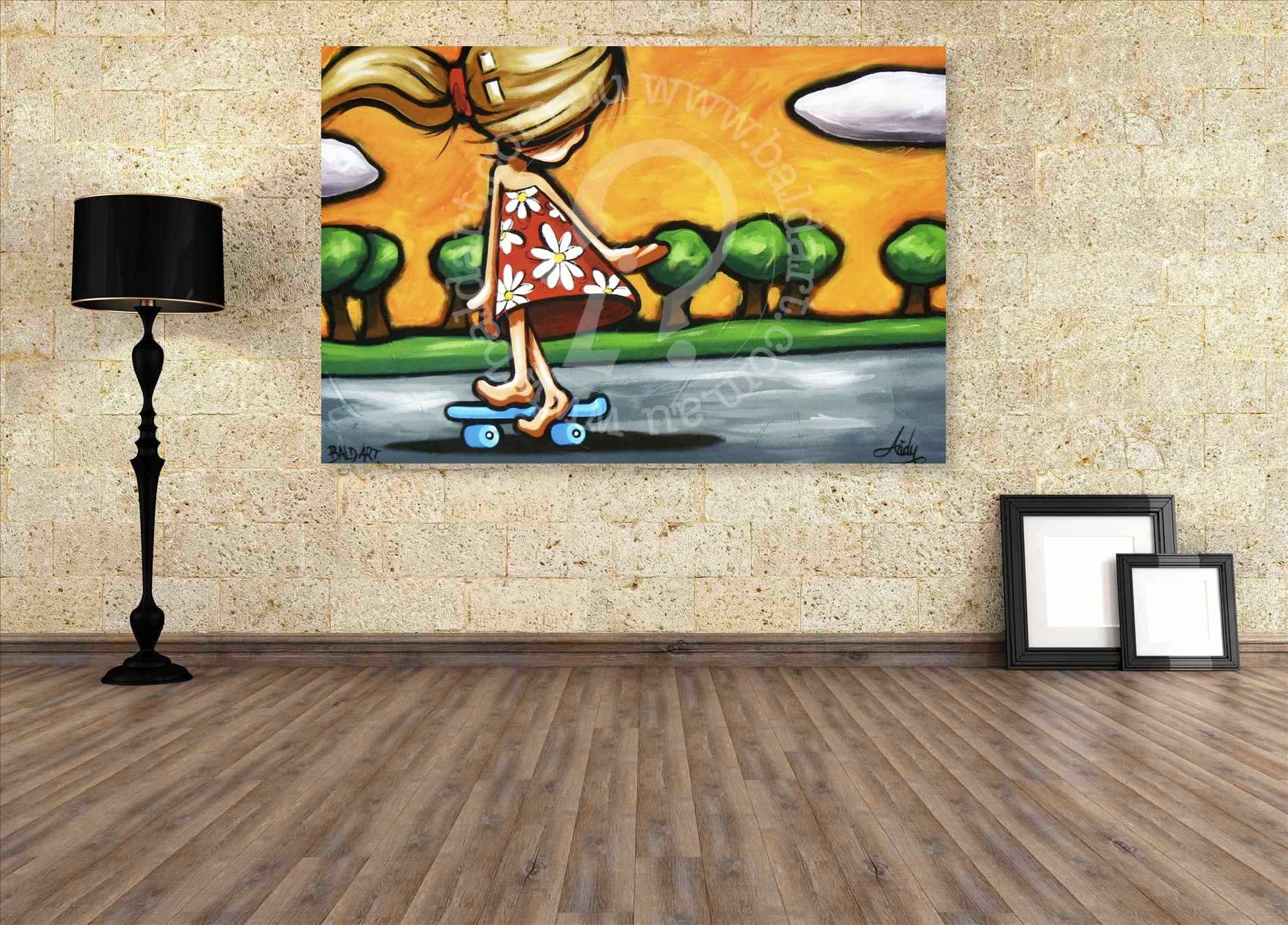 Painting of a woman on a skateboard hanging on a wall with a lamp and frames on a wooden floor.