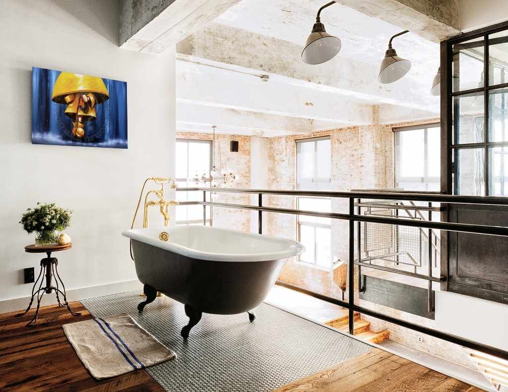 Modern bathroom with freestanding bathtub, large windows, and decorative elements.