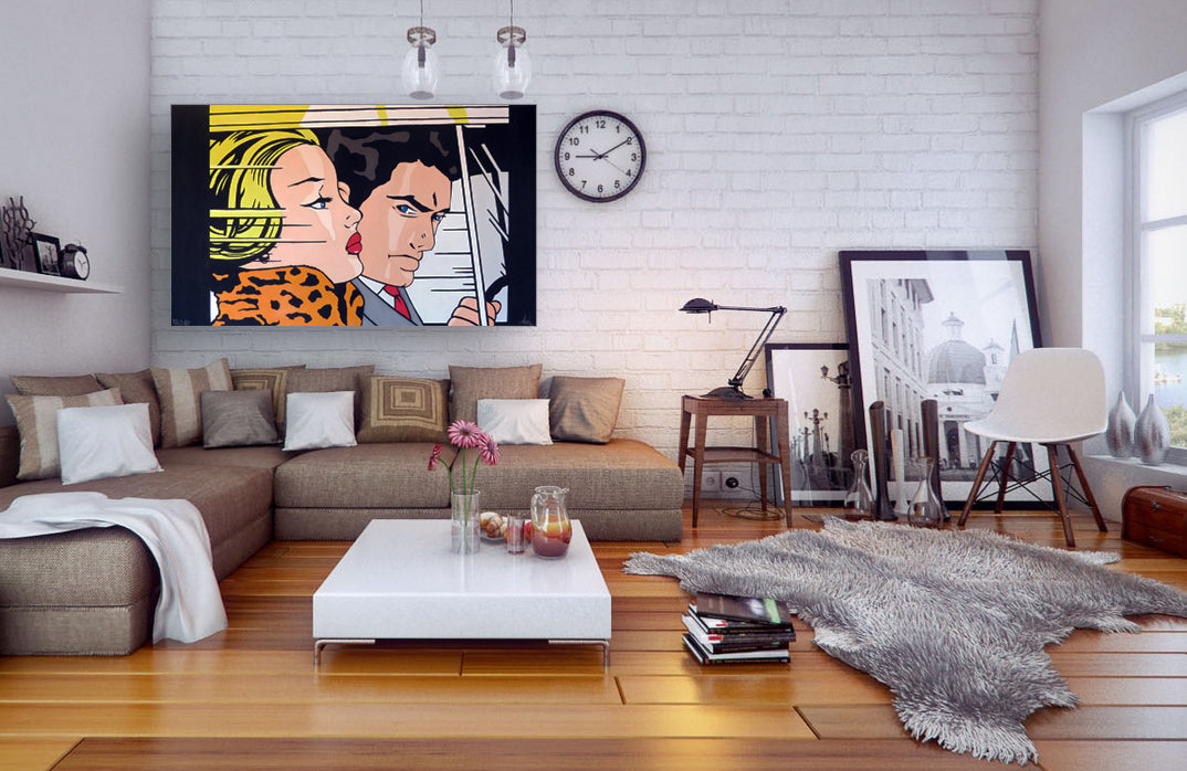 A cozy living room featuring a couch, coffee table, painting on the wall, and a clock above the table.