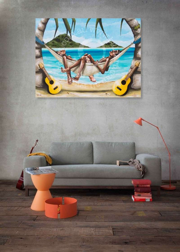 Living room with a painting of people in a hammock on a beach, gray sofa, and orange stool.