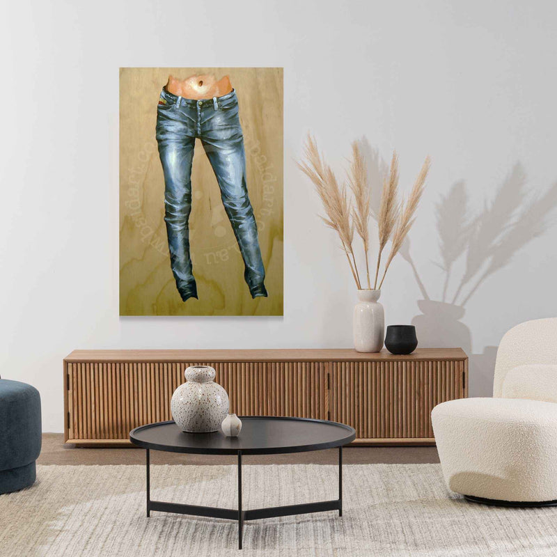 Modern living room with a painting of blue jeans on the wall, a wooden cabinet, and decorative items.