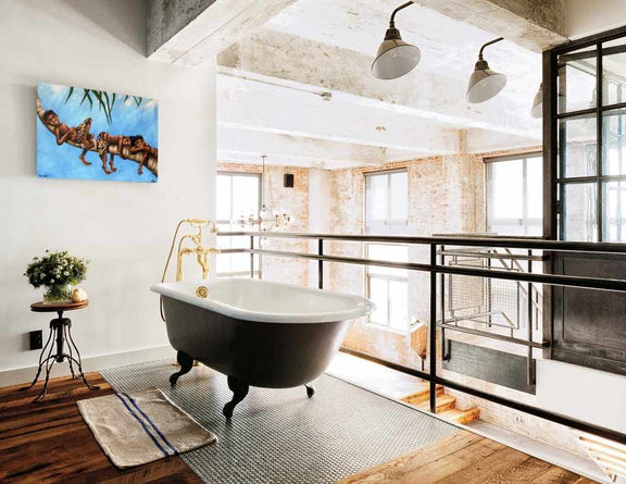 Modern bathroom with freestanding bathtub, large windows, and decorative elements.