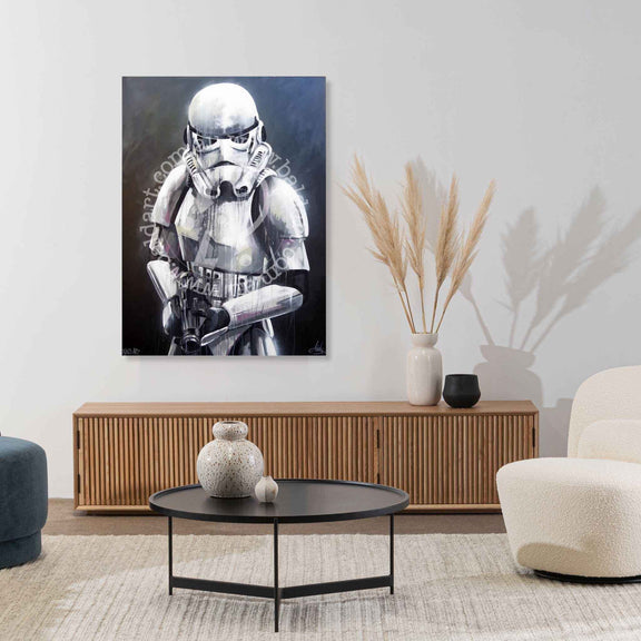 Living room with a stormtrooper painting on the wall, a coffee table, and decorative items.