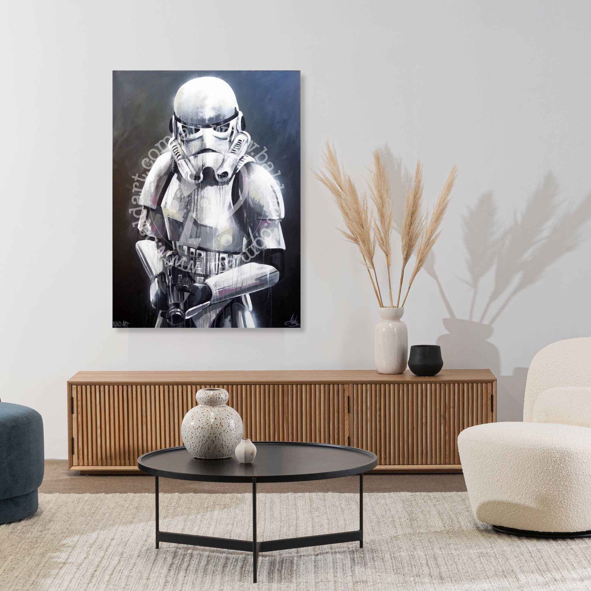Living room with a stormtrooper painting on the wall, a coffee table, and decorative items.
