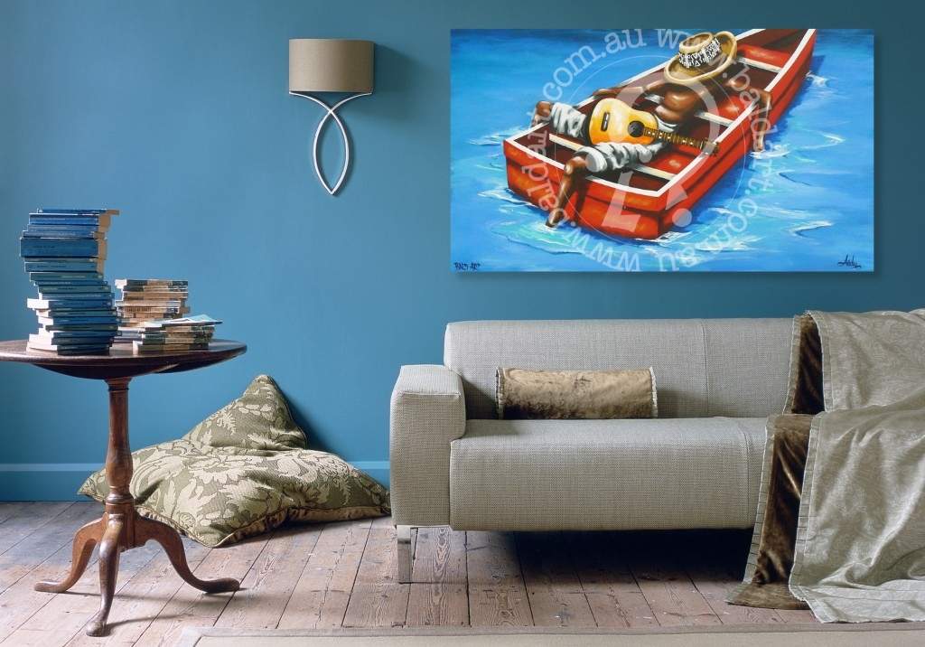 Living room with a gray sofa, small table, and a painting of a cartoon character in a boat on the wall.