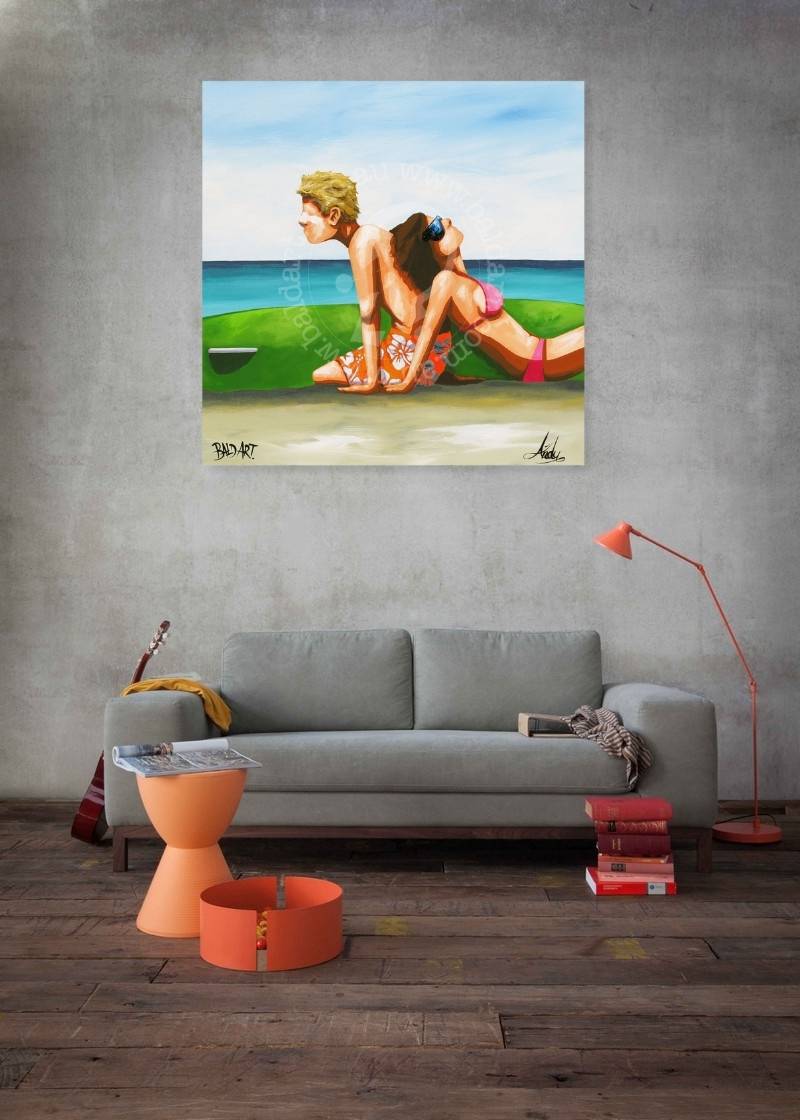 Living room with a painting of a couple on a beach above a gray sofa.