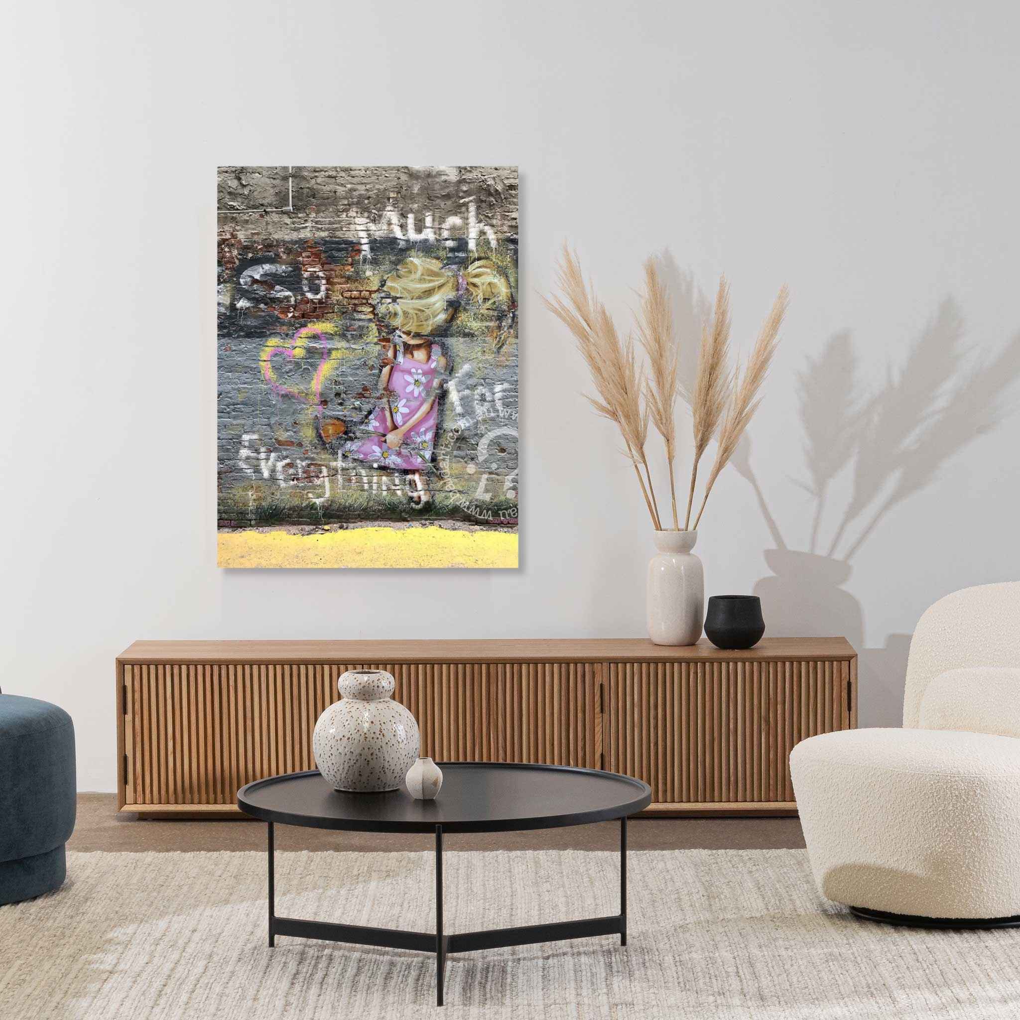 Living room with a painting on the wall, a wooden cabinet, and decorative items.