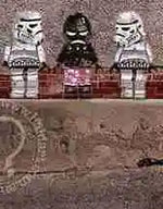Three LEGO figures, including a stormtrooper and a character in a pink dress, standing on a brick wall.