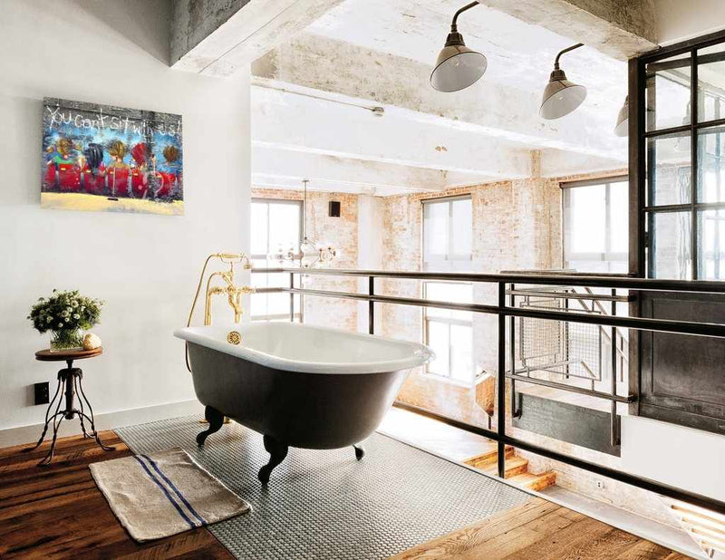 Modern bathroom with freestanding bathtub, large windows, and decorative elements.