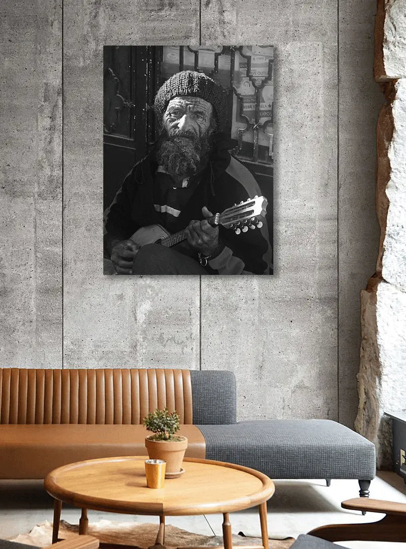 Living room with a painting of a man playing guitar on a concrete wall.