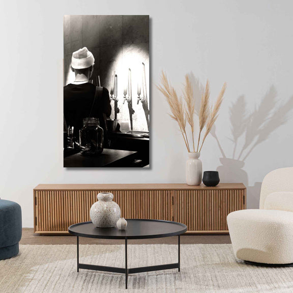 Modern living room with a large black and white painting, wooden cabinet, and decorative items.