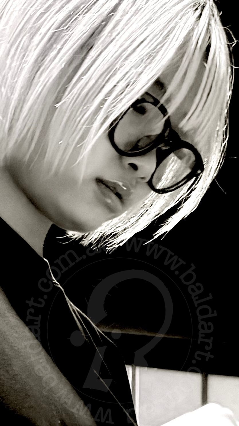 Black and white portrait of a person with glasses and a stylish haircut.
