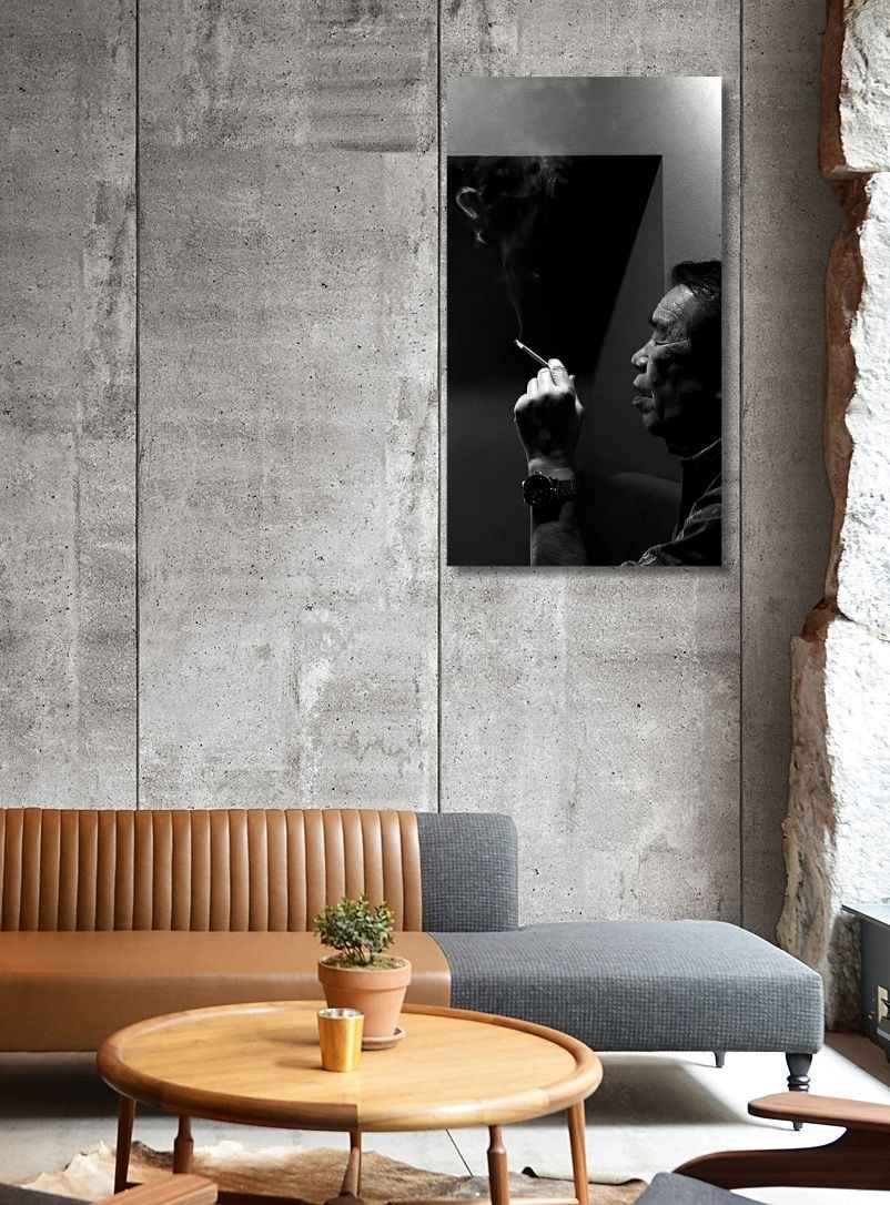 Modern living room with a concrete wall, wooden coffee table, and gray sofa.