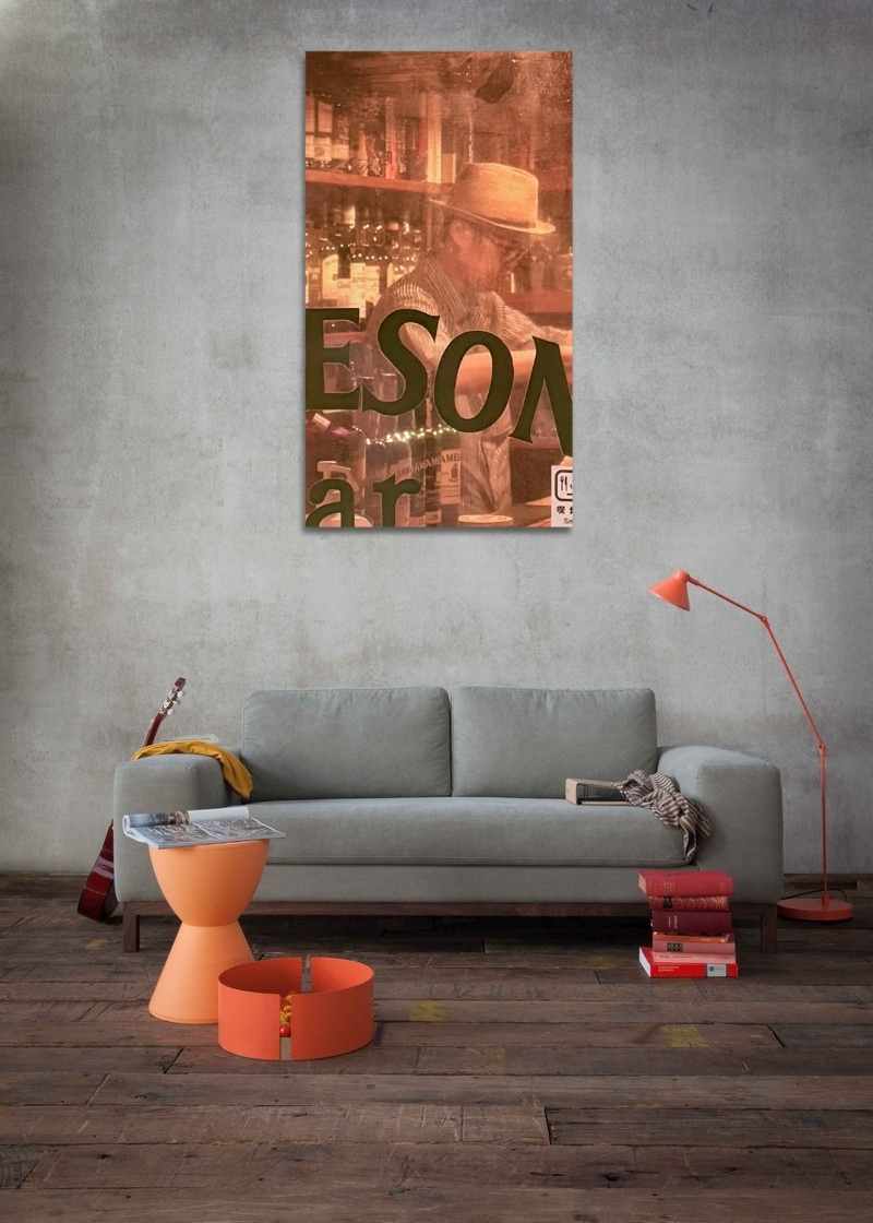Modern living room with a gray sofa, orange side table, and a large wall art piece.