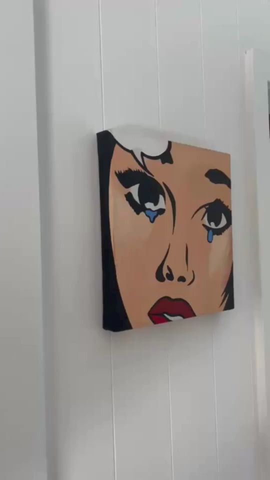 Video demonstrating a ready-to-hang canvas print being mounted on a wall, showcasing its lightweight frame and professional finish.