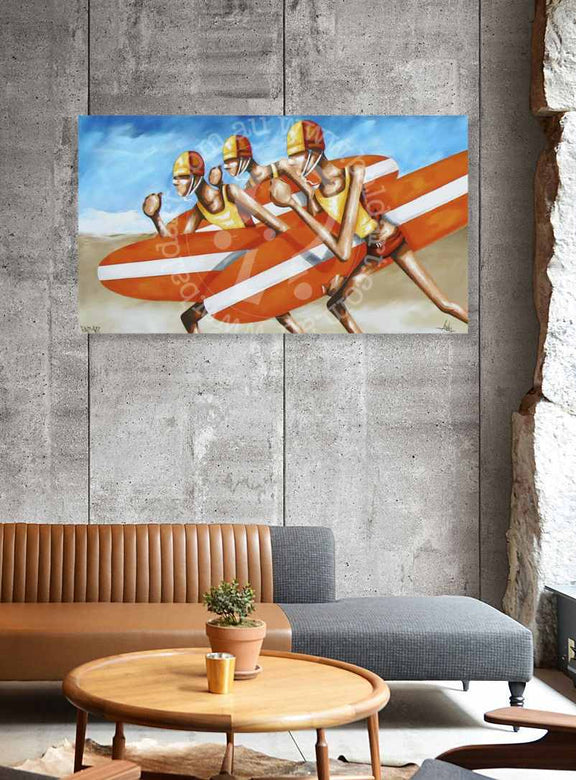 Painting of surfers on a wall above a living room with a couch and coffee table.