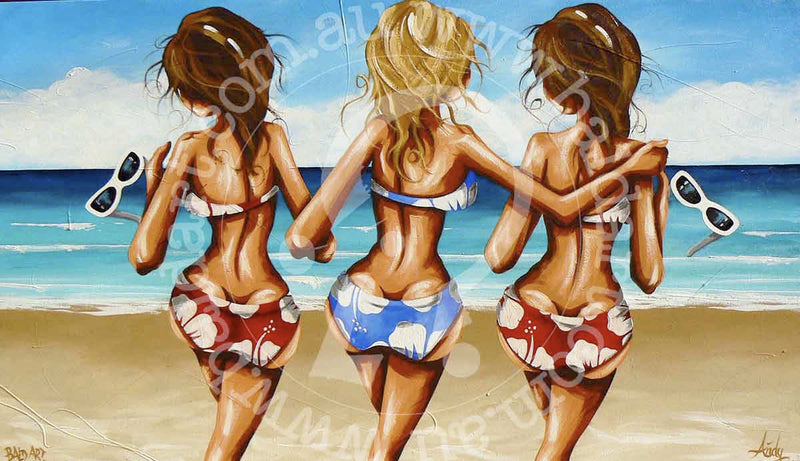 Three girls happily painting on the beach, surrounded by sand and waves, enjoying a sunny day together.