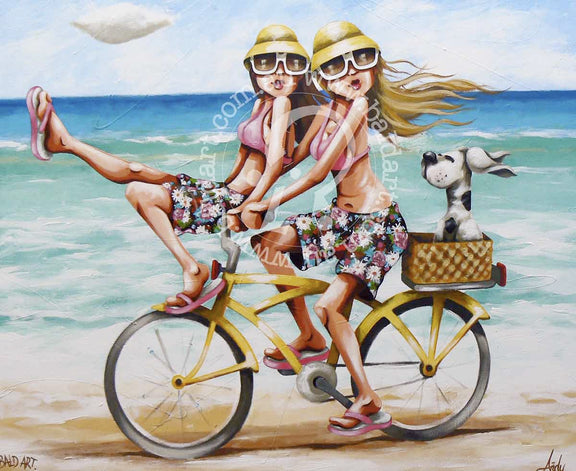 Two women ride a bike along the beach, happily accompanied by a playful dog running beside them.