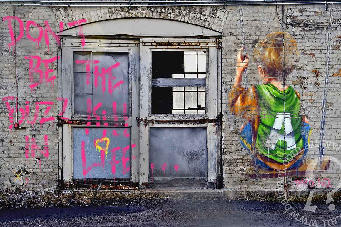 A piece of contemporary art featuring a stylized character with a spray paint can, predominantly in pink and gray tones, on a wall with visible graffiti.