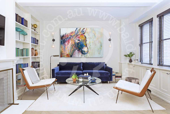 A living room showcasing a blue couch and a horse painting, blending comfort with artistic decor.