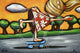 A colorful artistic representation of a person skateboarding with floral motifs on the skateboard and a vibrant background.