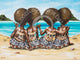 A canvas print featuring three stylized figures seated on a beach, with a vibrant blue ocean and sandy beach background. The figures are adorned in colorful traditional Fijian attire.