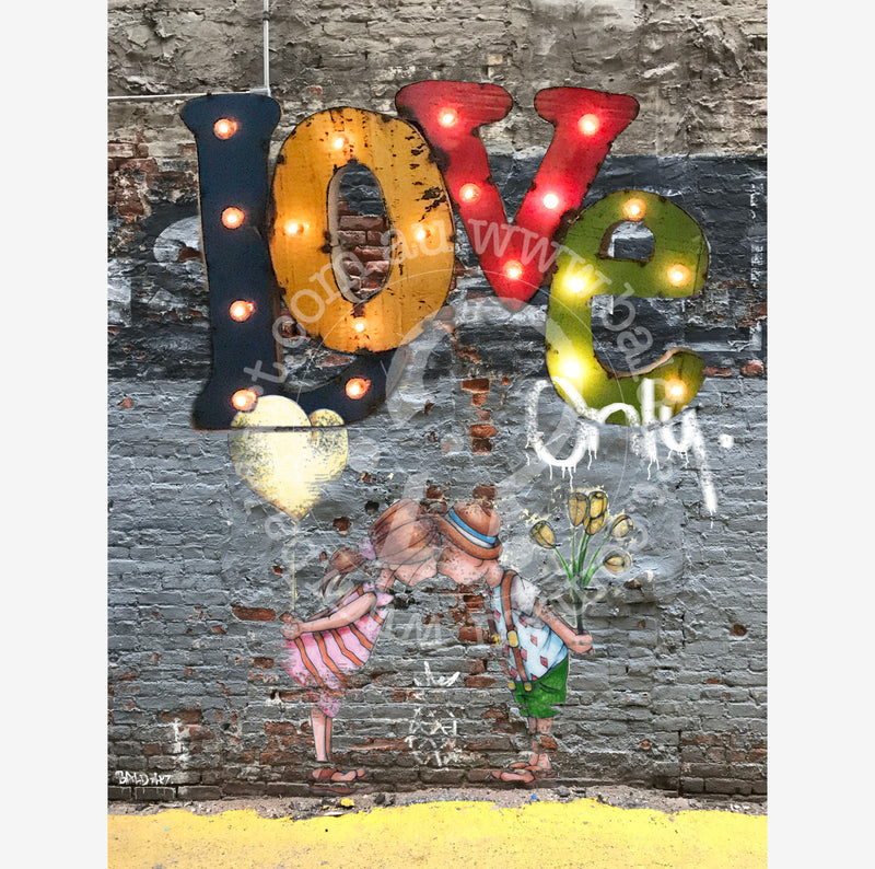 Wall art featuring the phrase "love only" in elegant typography against a textured background.