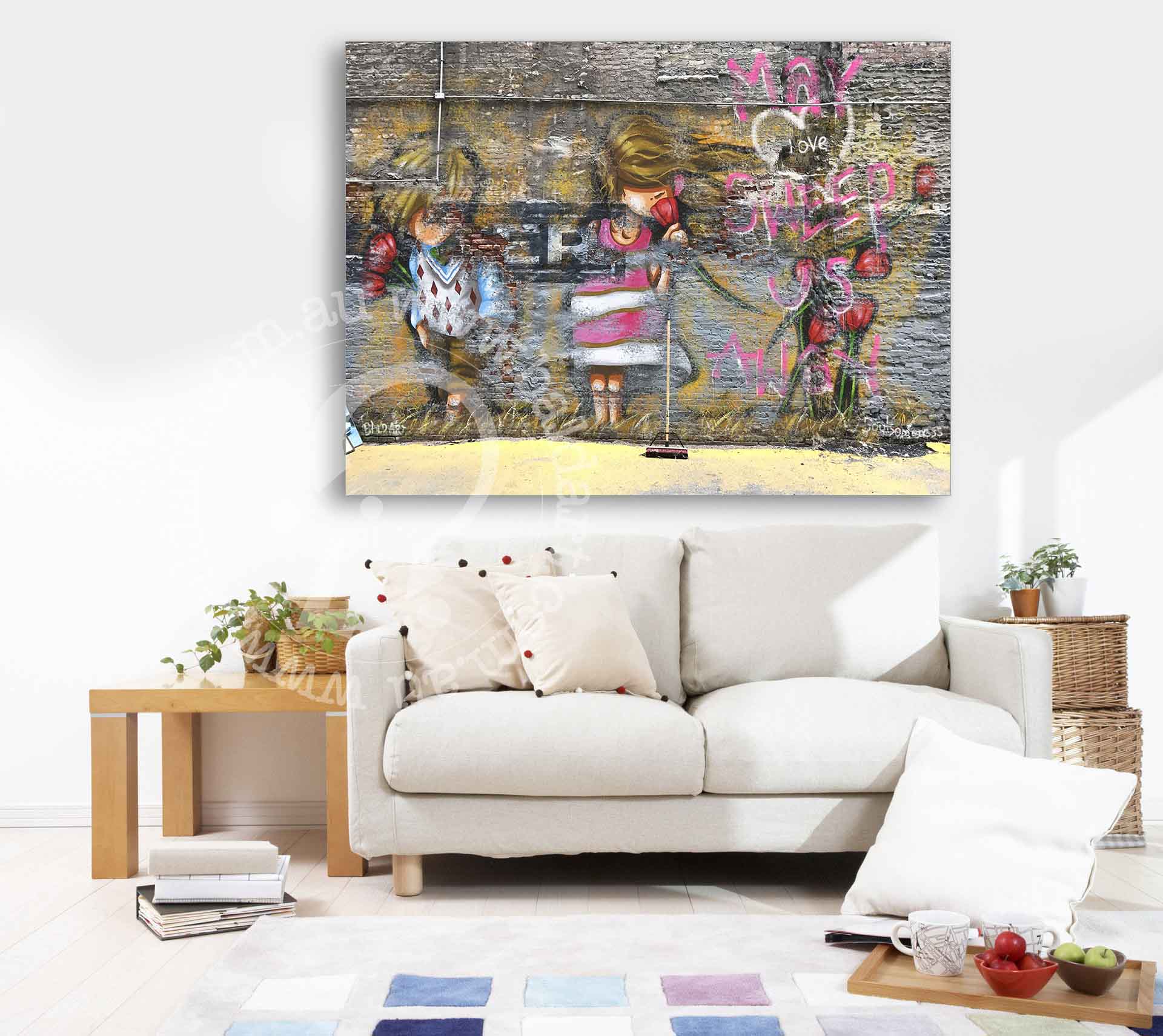 A cozy living room featuring a couch and a colorful painting hanging on the wall.