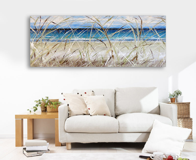 A serene beach landscape with grasses, beautifully framed and adorning a welcoming living room wall.