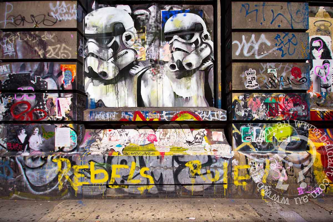 A graffiti-covered wall featuring a Stormtrooper alongside a popular Star Wars character in vibrant colors.