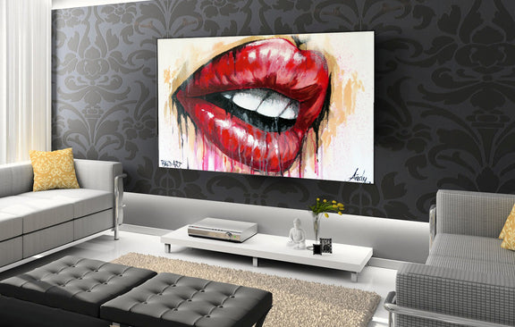 A stylish living room with a prominent painting of red lips, enhancing the room's modern aesthetic.
