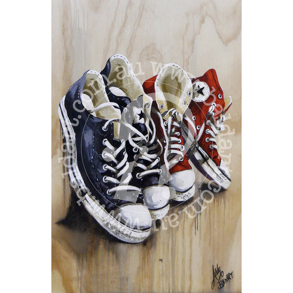 Vintage sneaker lineup art canvas showing red and black high top shoes on a warm wood grain background.