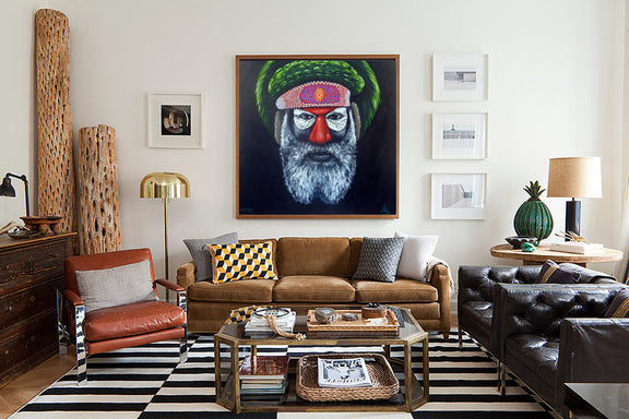 An elegant living room with a decorative painting on the wall, surrounded by tasteful furniture and a welcoming atmosphere.